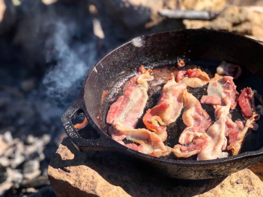 Best Camping Meals - Crispy bacon frying in pan