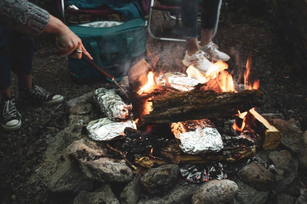 Foil packets cooking on campfire