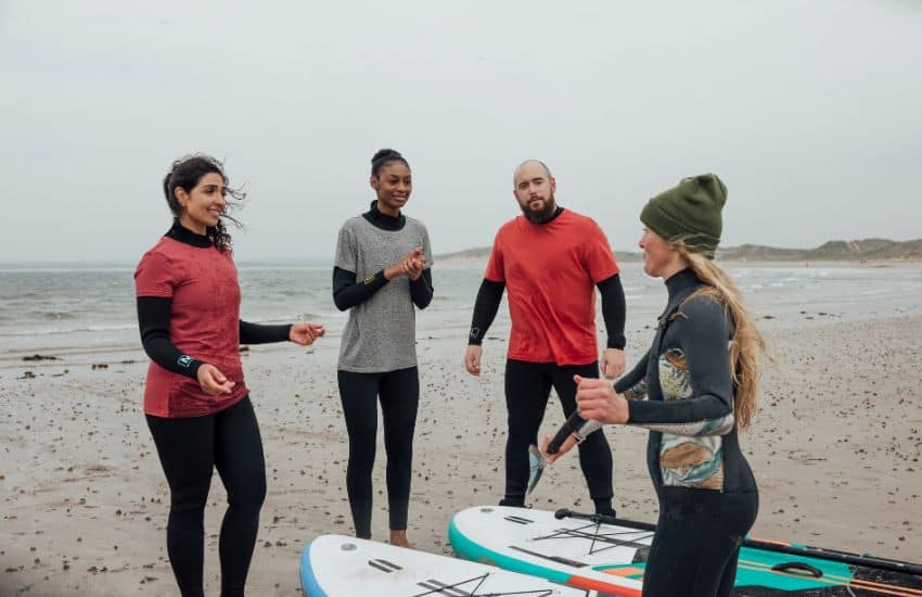 Instructor teaching beginners how to paddle board