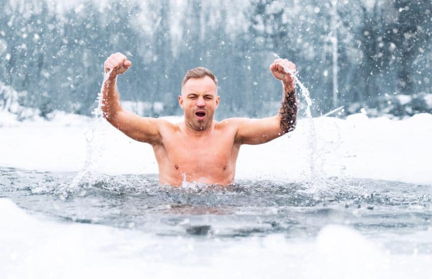 Man emerging from icy pool