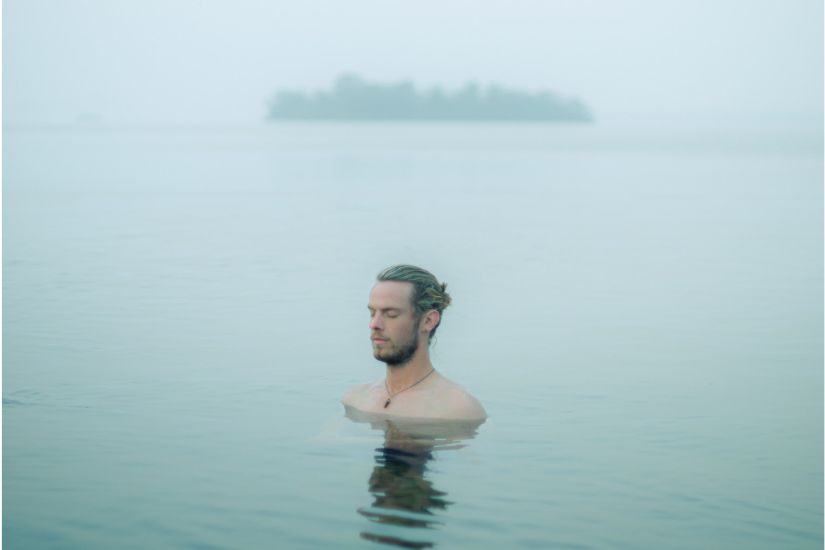 Man meditating in cold water
